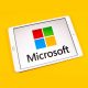 Tablet displaying the Microsoft logo and SQL Server 2019 branding on a bright yellow background, showcasing the software's identity.